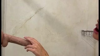 MILF with a perfect body takes a shower and gives a blowjob to a big dildo
