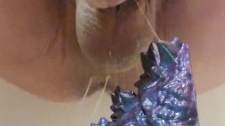 Asian male warms up with a quick dragon dildo fuck