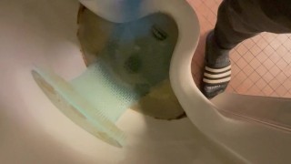 Wanking in urinal with blue nitrile gloves