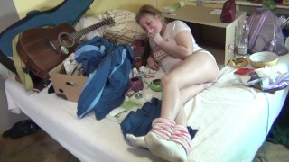 Crazy woman smokes and undresses while scavenging. Madness, disorder, laughter, striptease, cough.