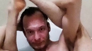 Legs behind the head in a bathtub while touching my cock and showing off feet soles