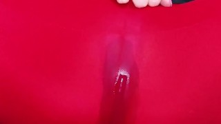 Teacher is pissing through red leggings under her desk in the classroom