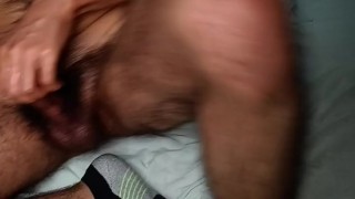 Guy with hairy lumberjack body jerking off his bushy dick and smelling musky socks and briefs