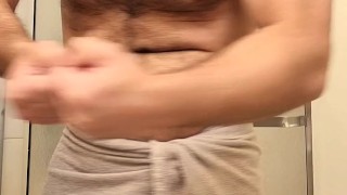 Hairy muscle bear flexing before shower
