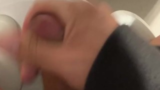 I jerk off in a public bathroom while someone pisses in the stall next to me