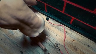 A man sucks a dildo and tries to sit on a wooden cock with his anus.