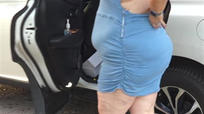 Pissing in public - busty milf in mini dress showing off big juicy ass and flashing pussy close up