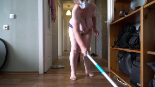 A mature, fat milf with big, natural, saggy tits is cleaning the apartment.