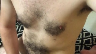 Cute guy cumming on his hairy body.