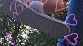 Dangling my house slippers on my toes.