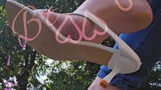 Dangling your favorite white slipper heels on my toes.