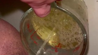 Girl measures her morning piss and overflows the cup