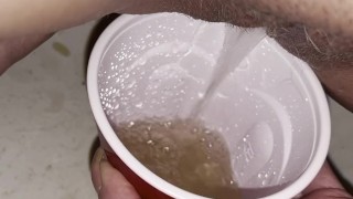 Girl pisses in red solo cup