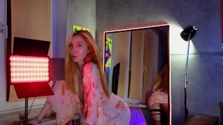 Cutie in a beautiful dress striptease in front of the mirror