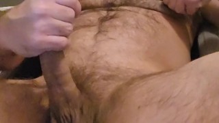 Hairy muscle bear stroking cock