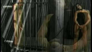 Babe with long hair peggs a prisoner in her prison cell