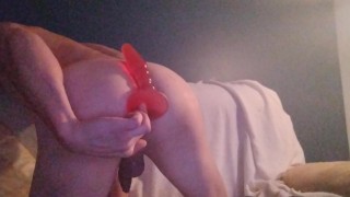 Boy uses buttplud while kneeling