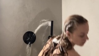 A beautiful girl takes a shower and Foam on boobs