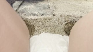 babe lifts up dress on steps to show her diaper while pissing and smoking