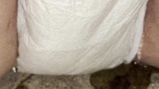 Babe wets her diaper outside while it becomes drenched in piss