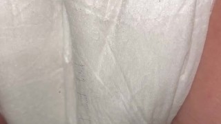 Girl pisses in diaper close up from behind