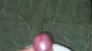 The guy masturbates his penis and cums