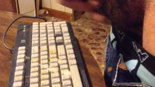 Masturbating until I shoot my load on a computer keyboard