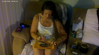 Busty girl in pink bra and panties smoking and playing video games