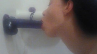 Sucking purple suction cup dildo in tub