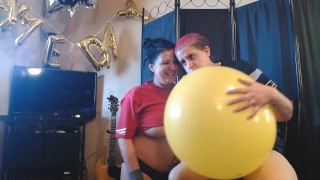 Lesbians Blowing up Big Yellow Balloon Superbowl Party Prep