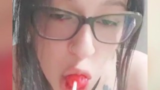 Big ass goth girl sucks a lollipop like a penis