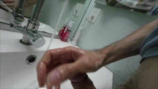 Amateur guy jerking huge cock and make cumshot at motel bathroom