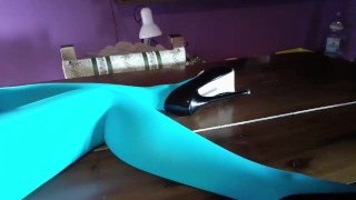 Milf with beautiful legs in pantyhose and heels lying on the table