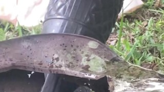 Squatting over a rusty can to let it all out, pissing like a nasty farm slut